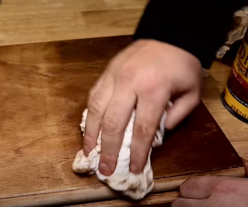 wiping wood stain with rag