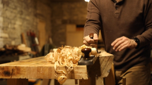 woodworker using a hand plane