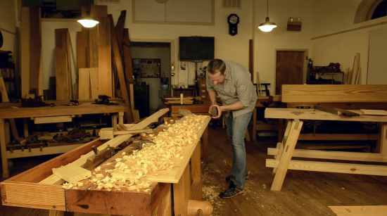 woodworker using a hand plane